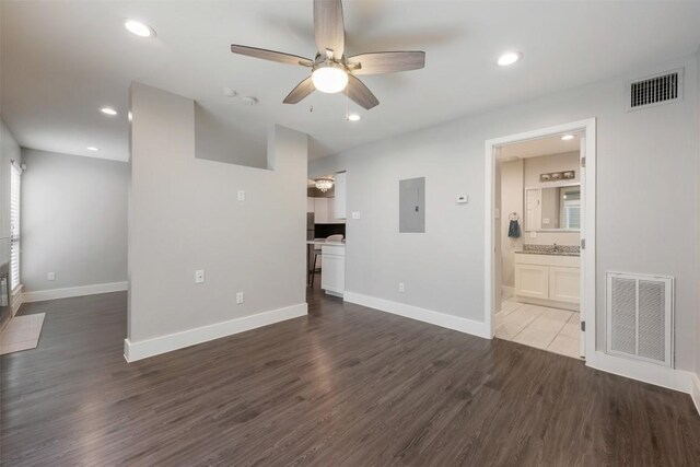 unfurnished living room featuring electric panel, tile patterned flooring, and ceiling fan