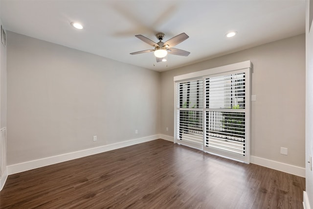 spare room featuring ceiling fan and dark hardwood / wood-style floors