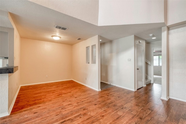 interior space featuring wood-type flooring and a textured ceiling