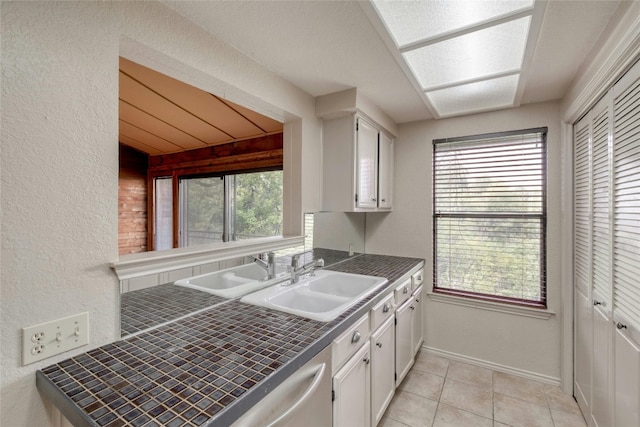 kitchen featuring white cabinets, plenty of natural light, and sink