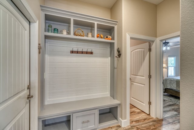 mudroom with a textured wall and light wood-type flooring