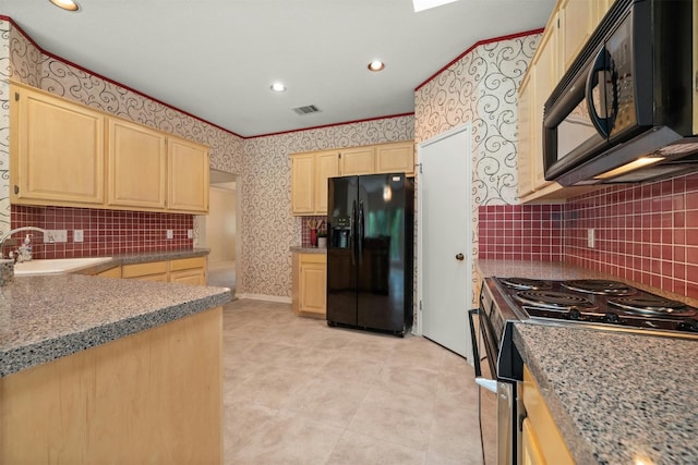 kitchen featuring black appliances, light brown cabinets, sink, and tasteful backsplash