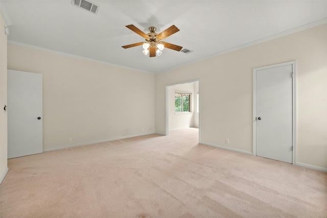 carpeted empty room featuring ceiling fan and ornamental molding