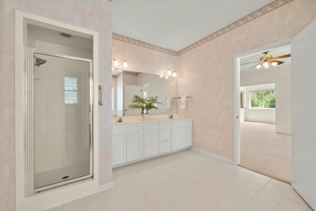 bathroom featuring tile patterned floors, ceiling fan, a shower with shower door, and vanity