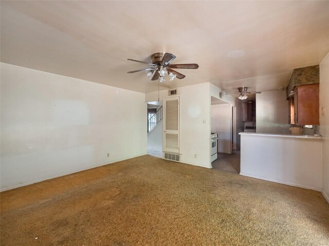 unfurnished living room featuring carpet and ceiling fan