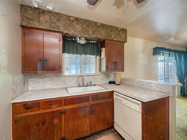 kitchen featuring light carpet, dishwasher, ceiling fan, sink, and kitchen peninsula