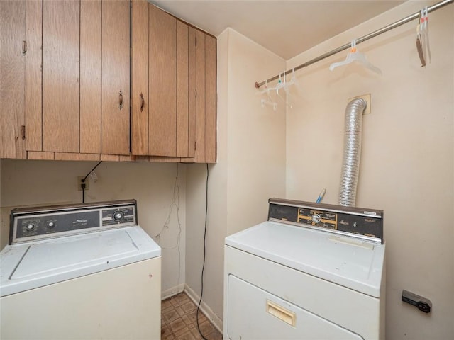 laundry area with separate washer and dryer, cabinet space, and baseboards