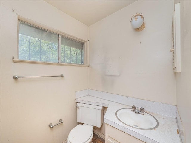 half bathroom featuring toilet and vanity