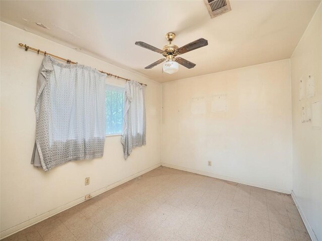 empty room with light tile patterned flooring and ceiling fan