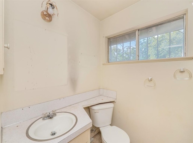 bathroom featuring toilet and vanity