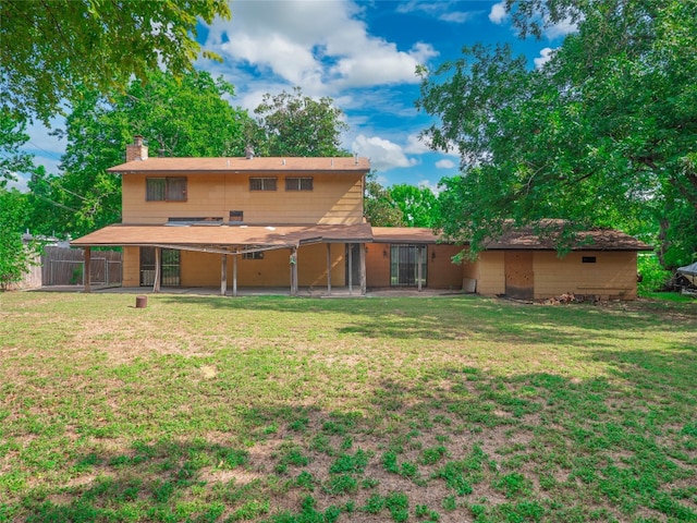 back of property featuring a yard