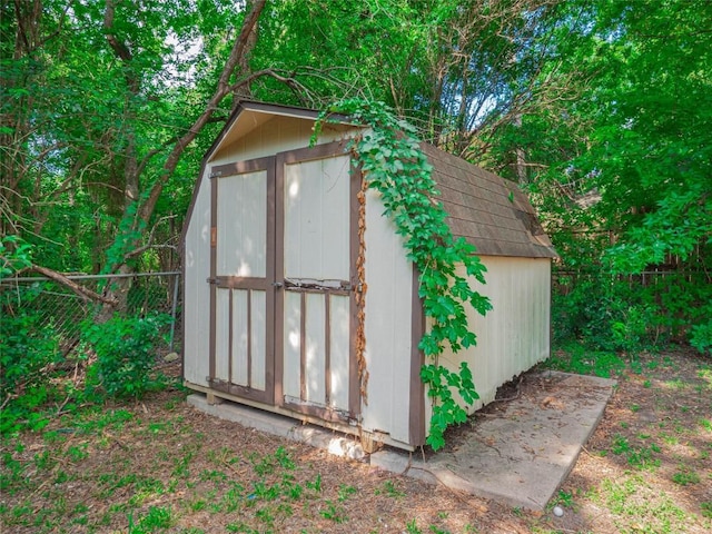 view of shed with fence