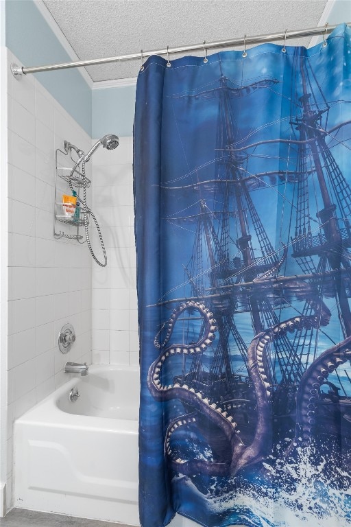 bathroom with a textured ceiling and shower / tub combo with curtain