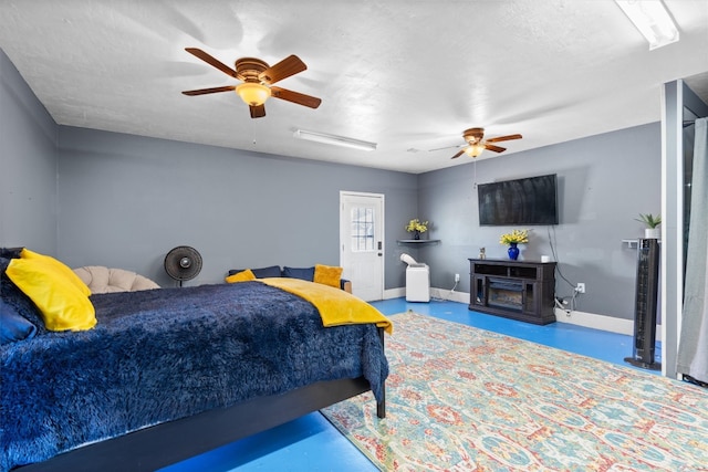 bedroom featuring ceiling fan and concrete flooring