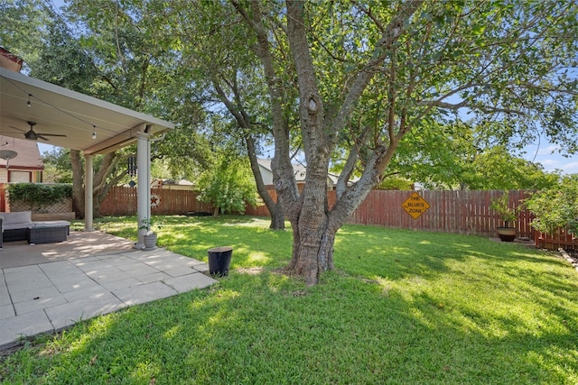 view of yard featuring ceiling fan and a patio area