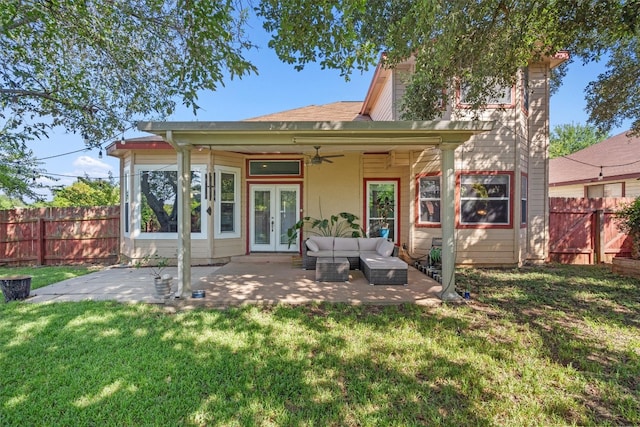 rear view of property with a yard, a patio area, and french doors