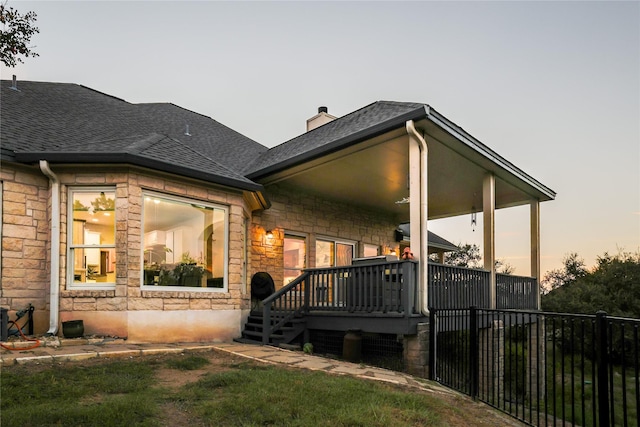 view of back house at dusk