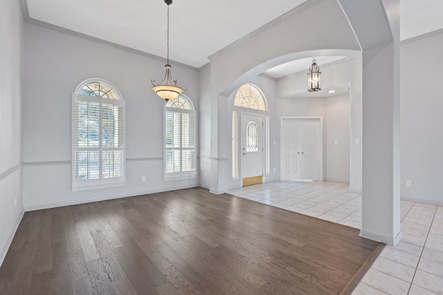 entryway featuring crown molding and light hardwood / wood-style floors