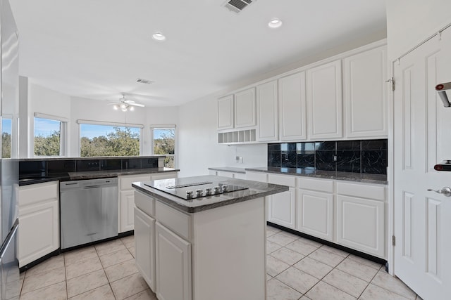 kitchen featuring dishwasher, white cabinets, light tile patterned floors, a center island, and black electric cooktop