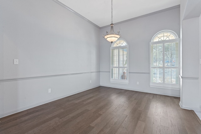 unfurnished room featuring crown molding and dark wood-type flooring