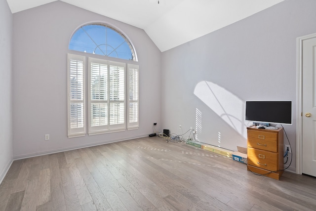 interior space featuring light wood-type flooring and lofted ceiling