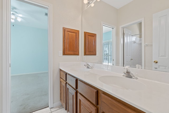 bathroom with tile patterned flooring, ceiling fan, and vanity