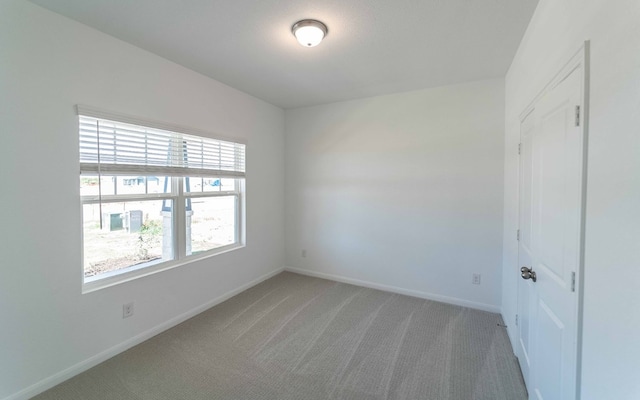 unfurnished room with light carpet