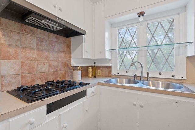 kitchen featuring backsplash, black gas stovetop, white cabinetry, and plenty of natural light