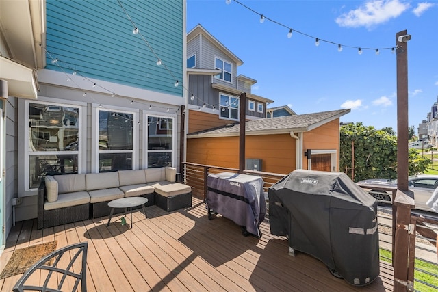 wooden terrace featuring area for grilling and an outdoor living space