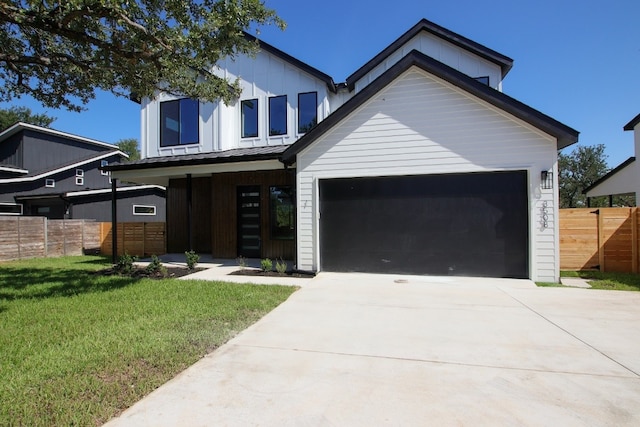 view of front of property featuring a front yard and a garage