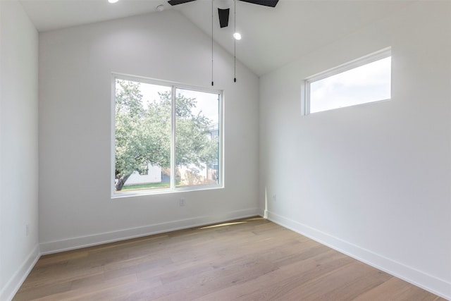 unfurnished room with ceiling fan, a wealth of natural light, high vaulted ceiling, and light hardwood / wood-style flooring