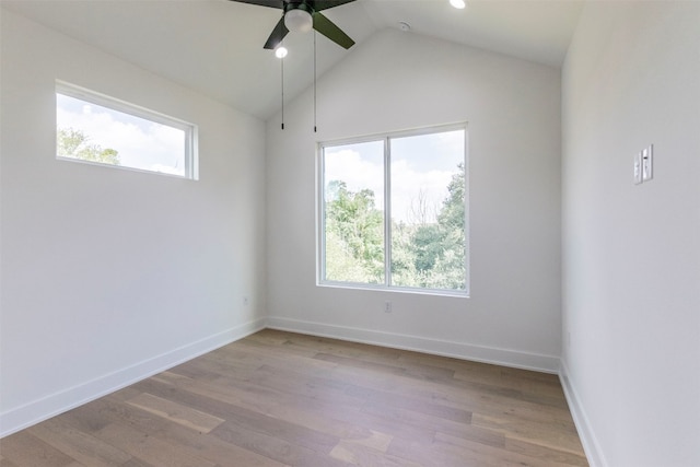 spare room with ceiling fan, lofted ceiling, and hardwood / wood-style floors