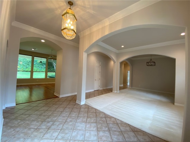 unfurnished room with ornamental molding, light hardwood / wood-style flooring, and a chandelier