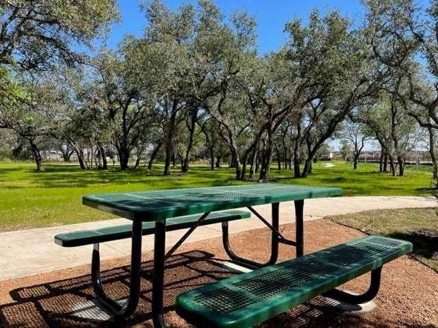 view of property's community with a lawn