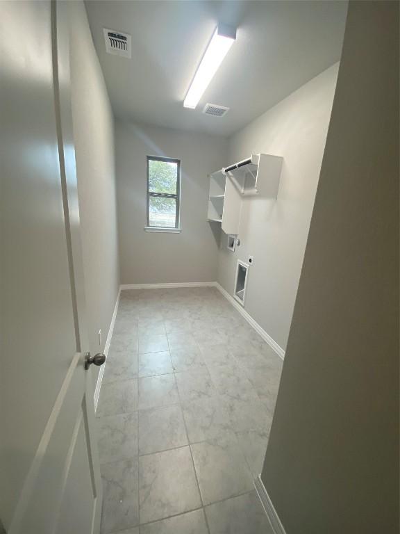 clothes washing area with gas dryer hookup, laundry area, visible vents, and electric dryer hookup