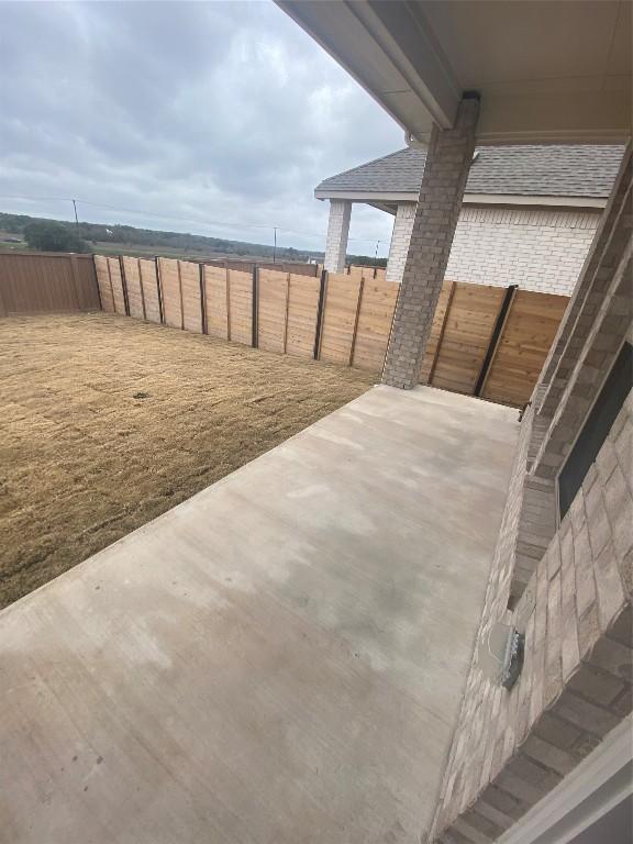 view of patio / terrace featuring fence