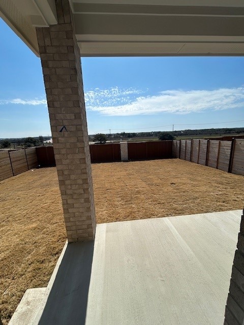 view of yard featuring a patio area and a fenced backyard