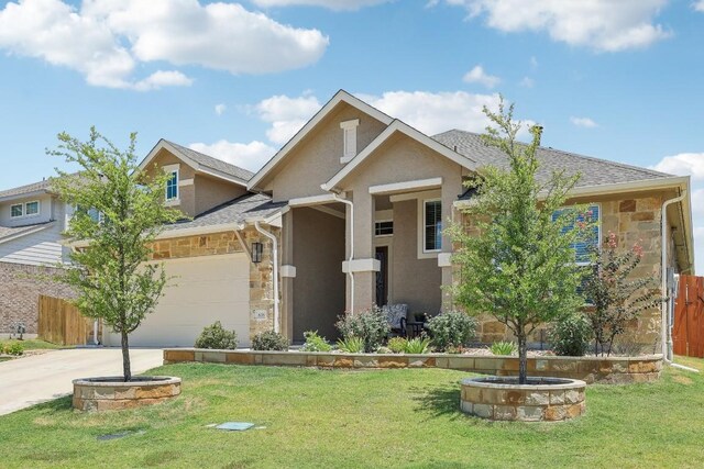 view of front of property with a garage and a front lawn