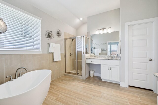 bathroom featuring plus walk in shower, tile patterned floors, and vanity