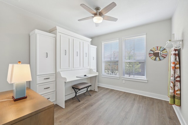 office area featuring ceiling fan, light hardwood / wood-style flooring, and a healthy amount of sunlight