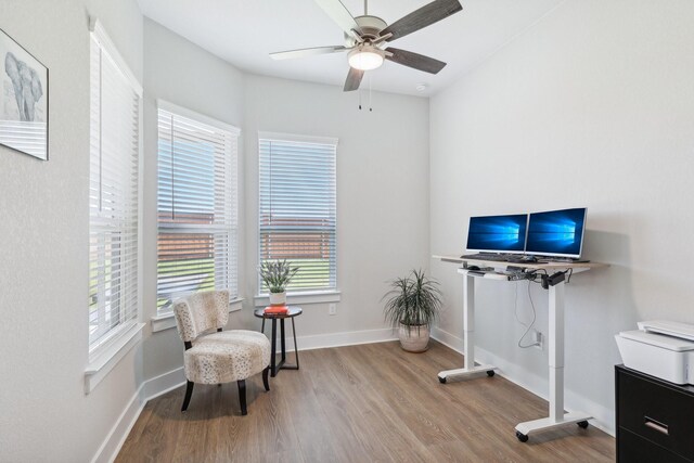 living area with ceiling fan and light wood-type flooring