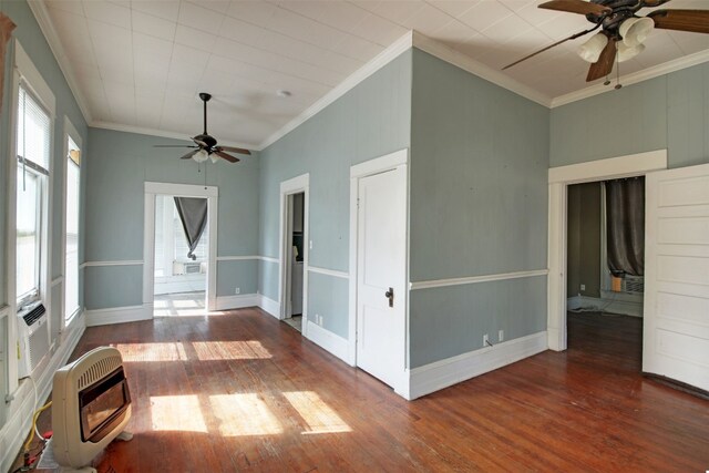 empty room with ceiling fan, crown molding, wood-type flooring, and a wealth of natural light