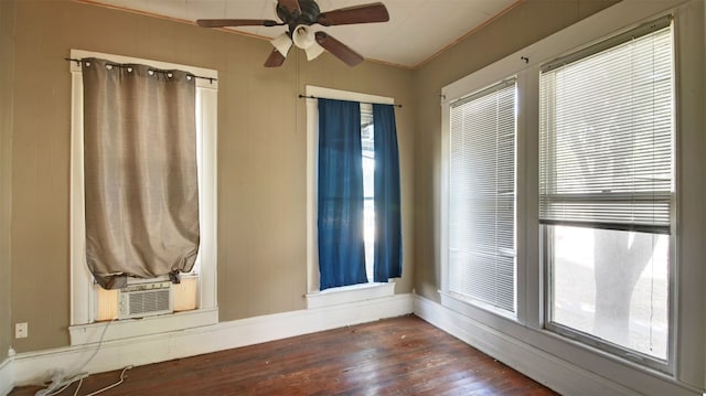 unfurnished room featuring ornamental molding, dark wood finished floors, and a wealth of natural light