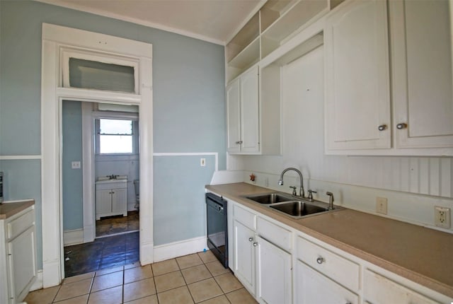 kitchen with light tile patterned flooring, dishwasher, a sink, and white cabinetry