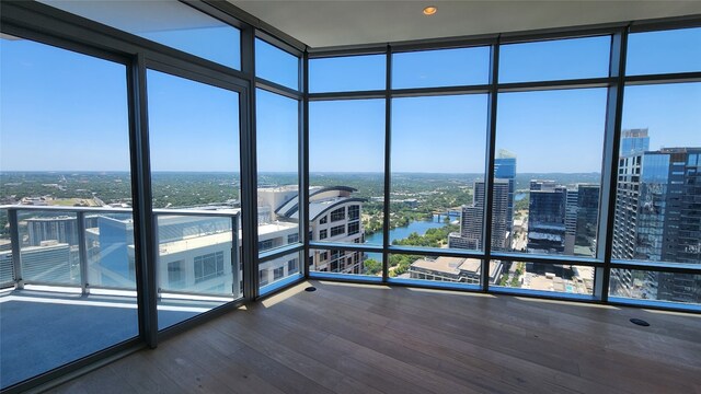 interior space featuring expansive windows and wood-type flooring