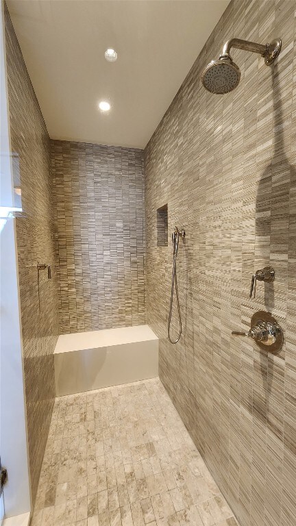 bathroom with a tile shower