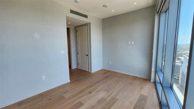 unfurnished room with light hardwood / wood-style floors