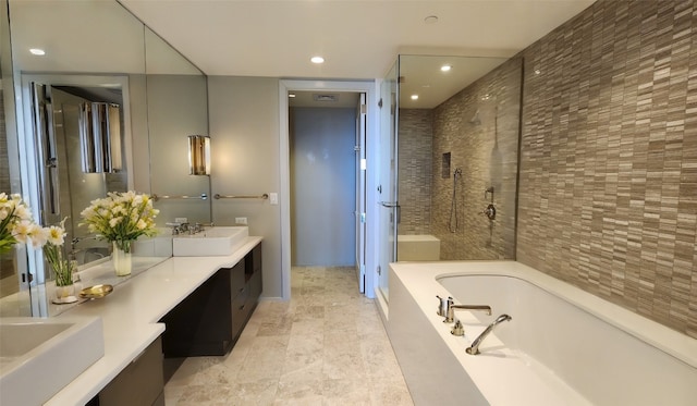 bathroom with double sink vanity, tile patterned floors, and independent shower and bath