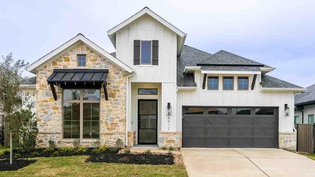 modern farmhouse with board and batten siding, a front yard, roof with shingles, and driveway