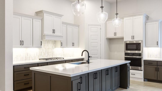 8512 Picnic House Path, Austin, TX 78744 - kitchen with stainless steel appliances, a sink, white cabinetry, and decorative backsplash